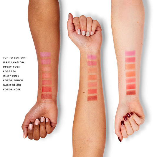 a woman's hands with different shades of lipstick