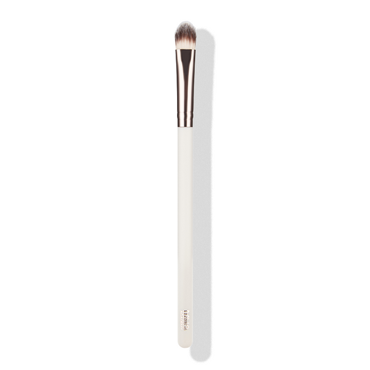 a white and gold makeup brush