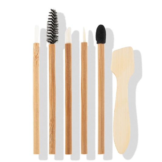 a group of brushes with a wooden spatula