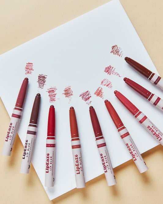 a group of red and white markers on a piece of paper