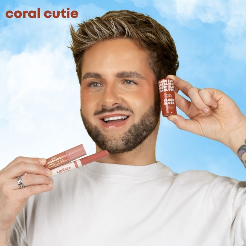 a man holding lipsticks and smiling