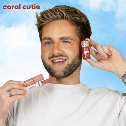 a man holding lipsticks and smiling