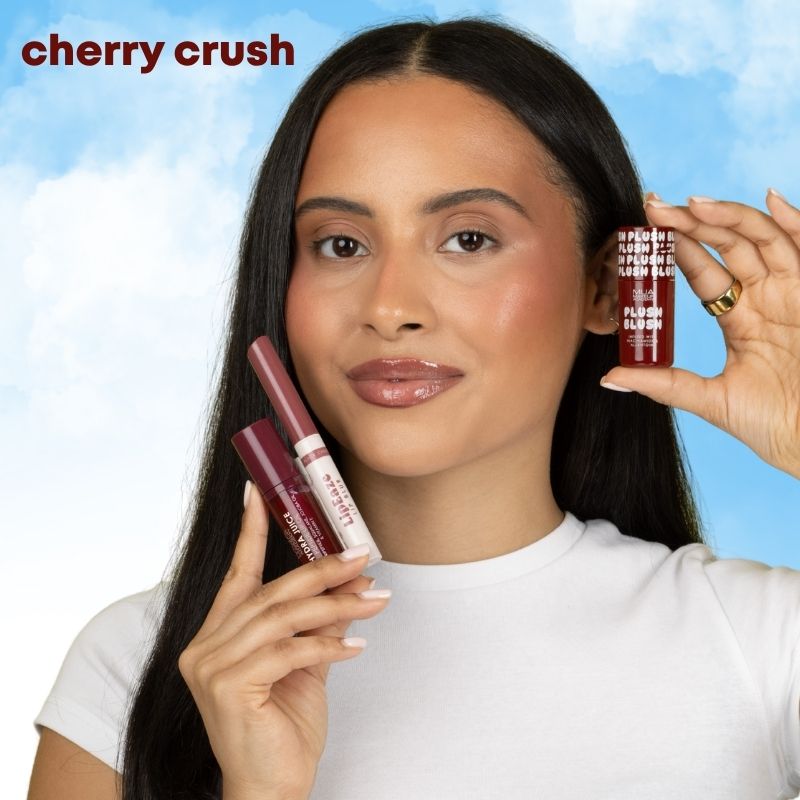 a woman holding two lip glosses
