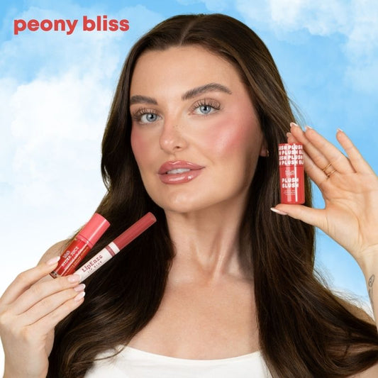 a woman holding two lipsticks