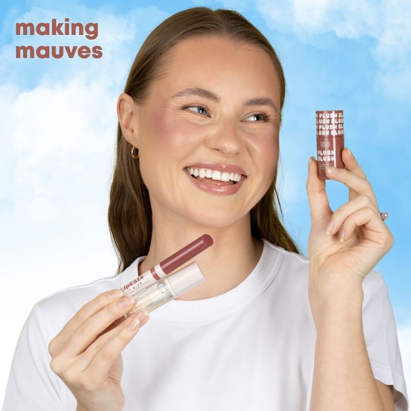 a woman holding a tube of lipstick