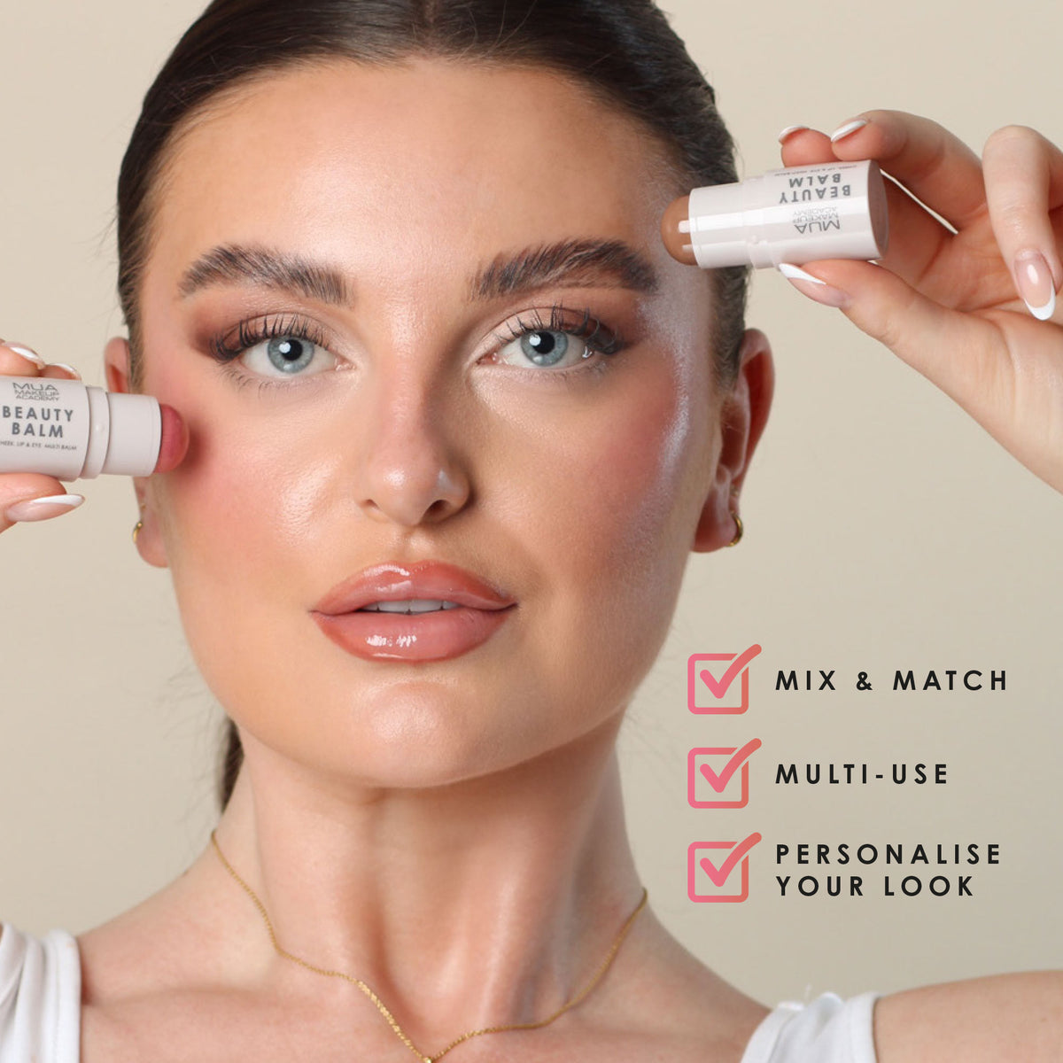 a woman holding a tube of makeup