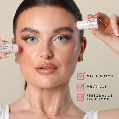 a woman holding a tube of makeup