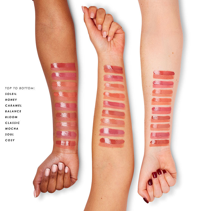 a woman's hands with different lipsticks