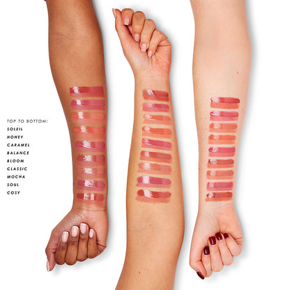 a woman's hands with different lipsticks