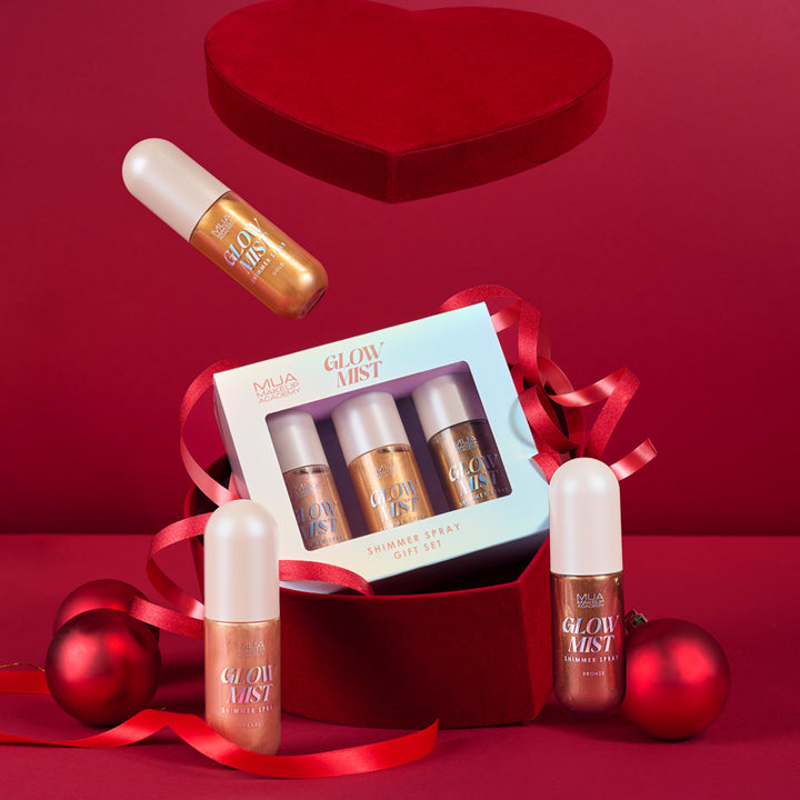 a box with a red heart shaped box with a few small bottles of makeup