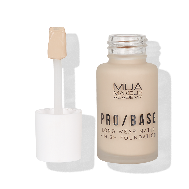 a bottle of makeup foundation with a brush