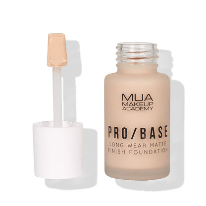 a bottle of foundation with a brush