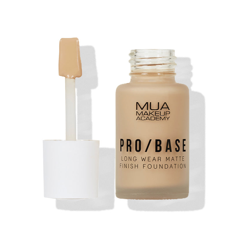a bottle of foundation with a brush