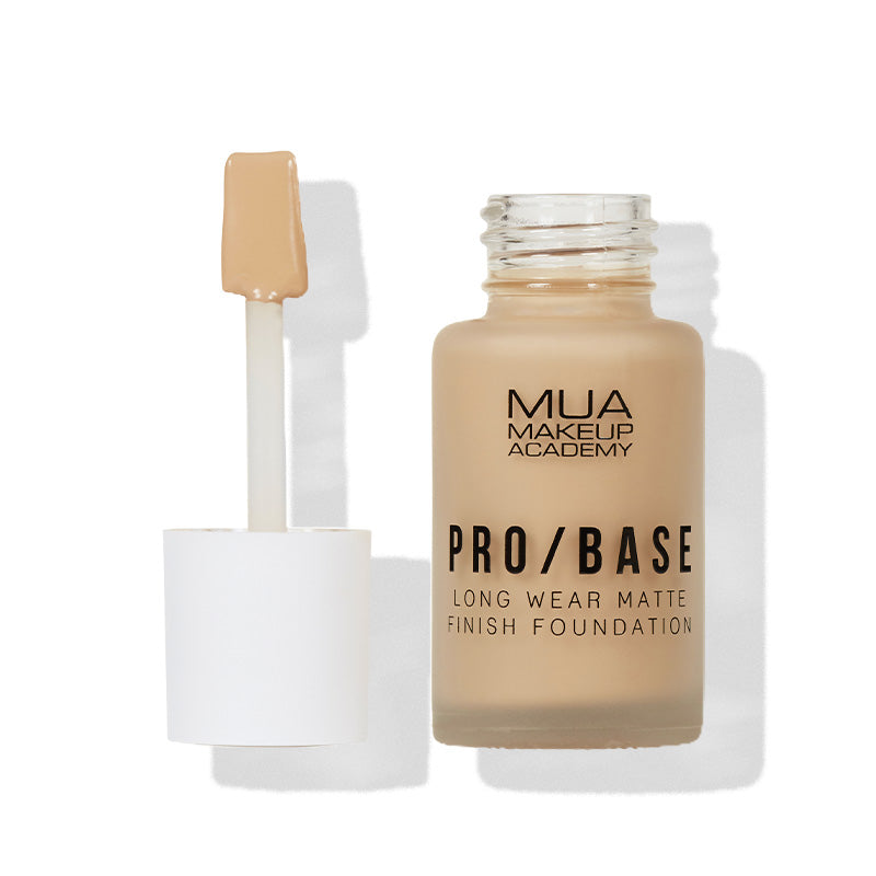 a bottle of foundation with a brush