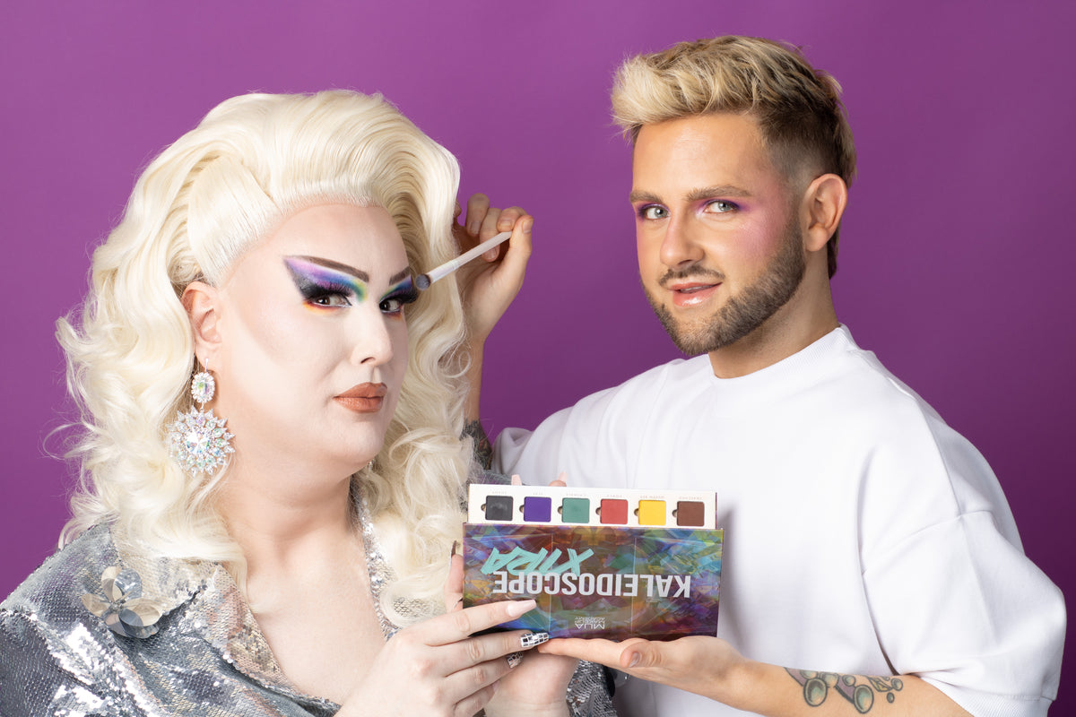 a man holding a brush and a woman with a makeup brush
