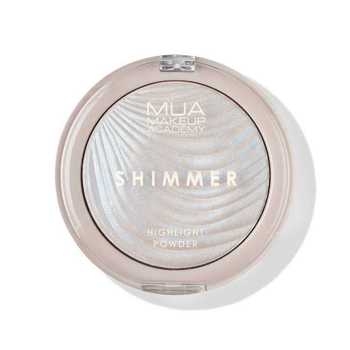 a round container with a white and gold powder in it