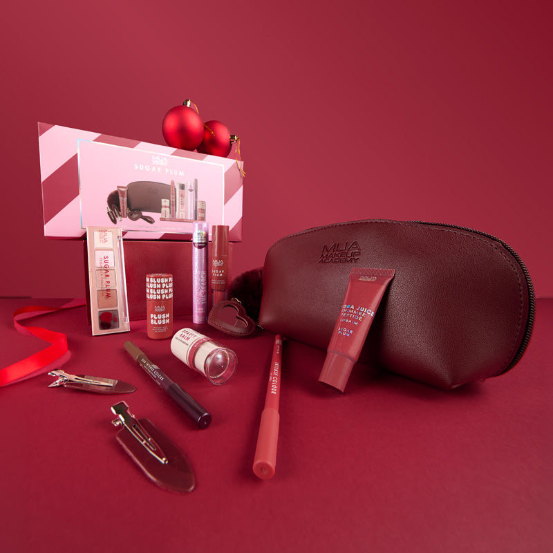 a group of makeup products on a red surface