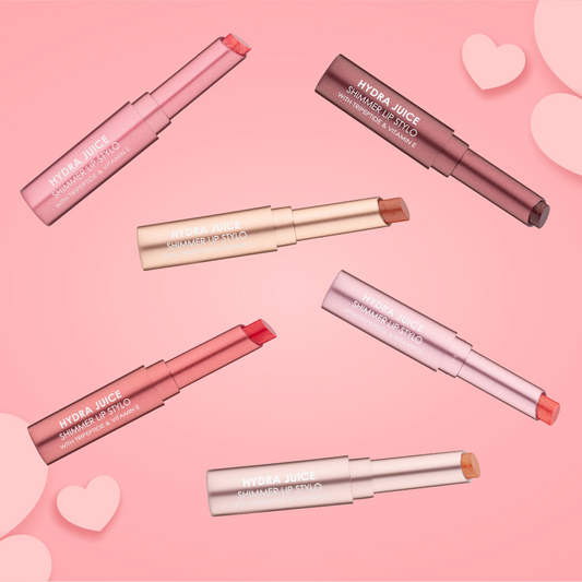 a group of lipsticks on a pink background