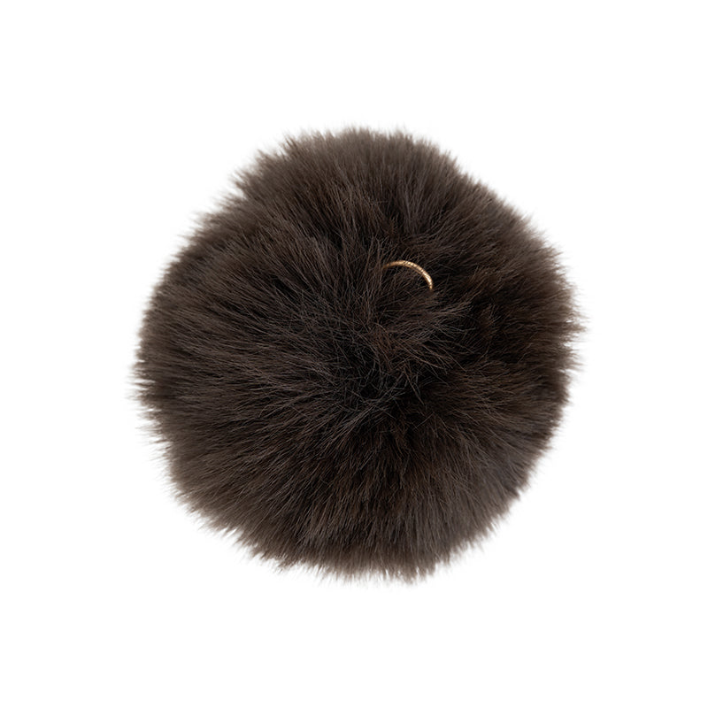 a black fluffy ball with a ring on it