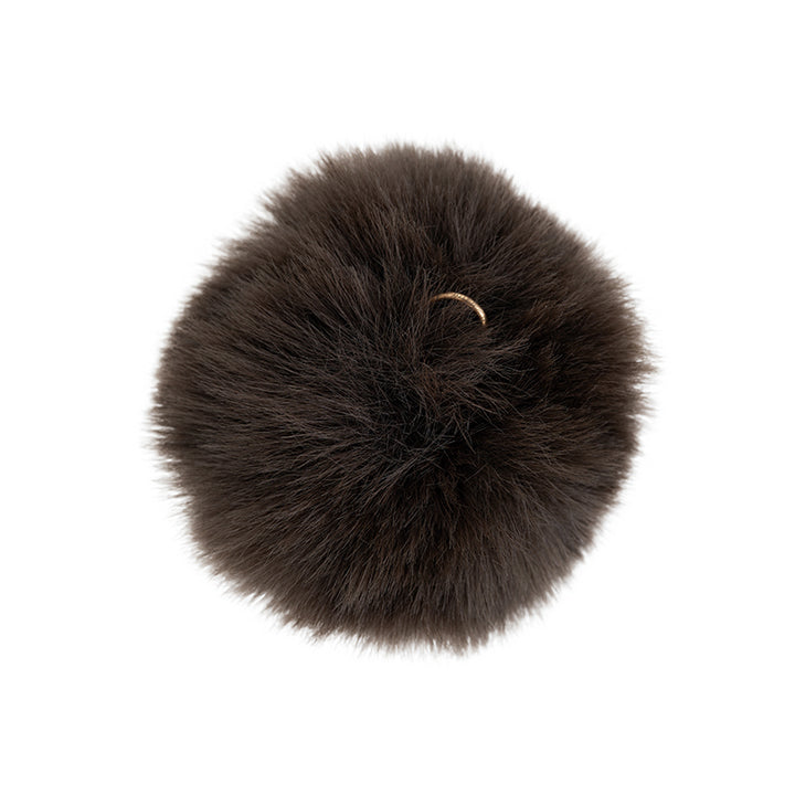 a black fluffy ball with a ring on it