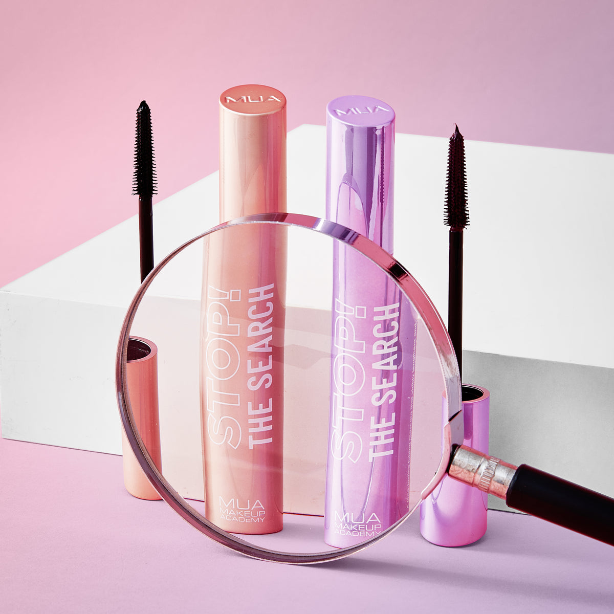 a magnifying glass on a white box with mascara