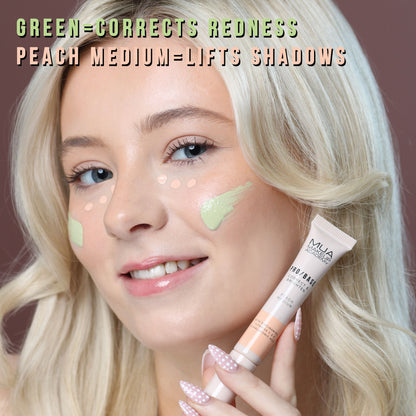 a woman holding a tube of foundation