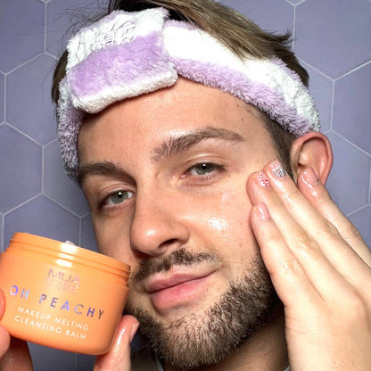 a man holding a jar of cream