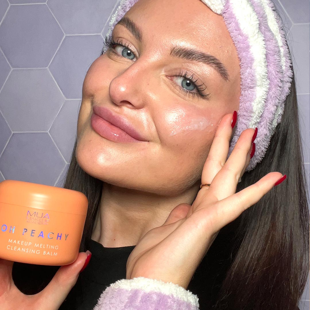 a woman holding a jar of face cream