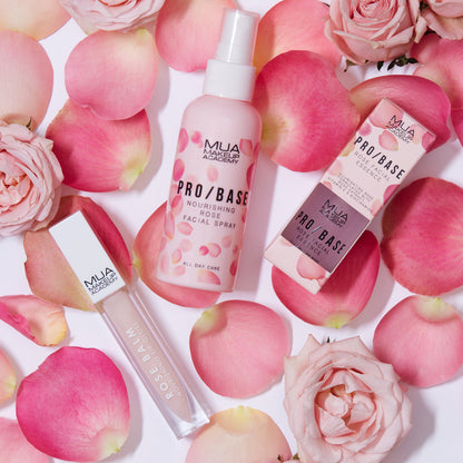 a group of pink roses and bottles of cosmetics